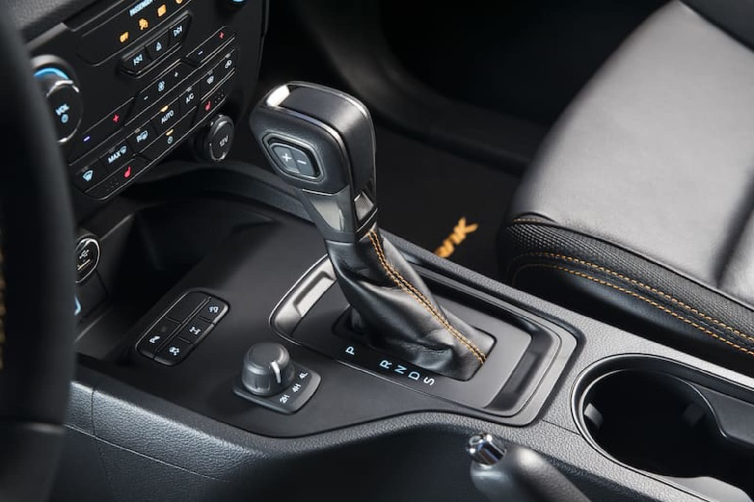 a close up of a car dashboard with a steering wheel and a dash board with buttons and a control panel