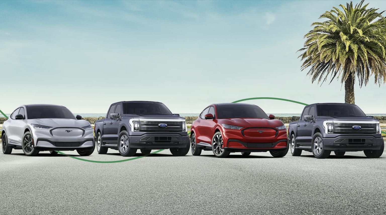 A lineup of various SUV models, including a red one in the center, parked on a paved surface with palm trees in the background.