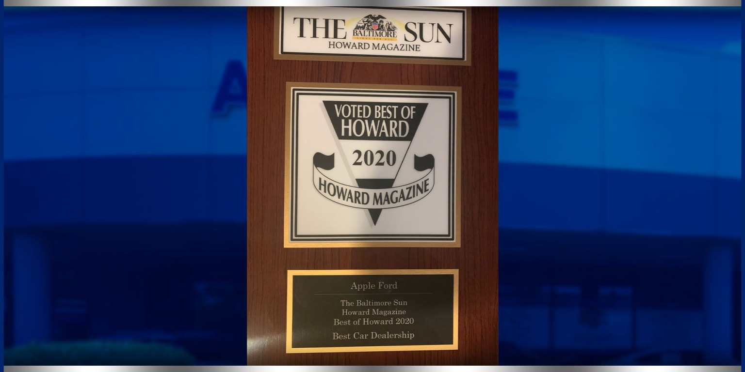 a picture of a plaque with a picture of a man in a suit and tie in front of a building