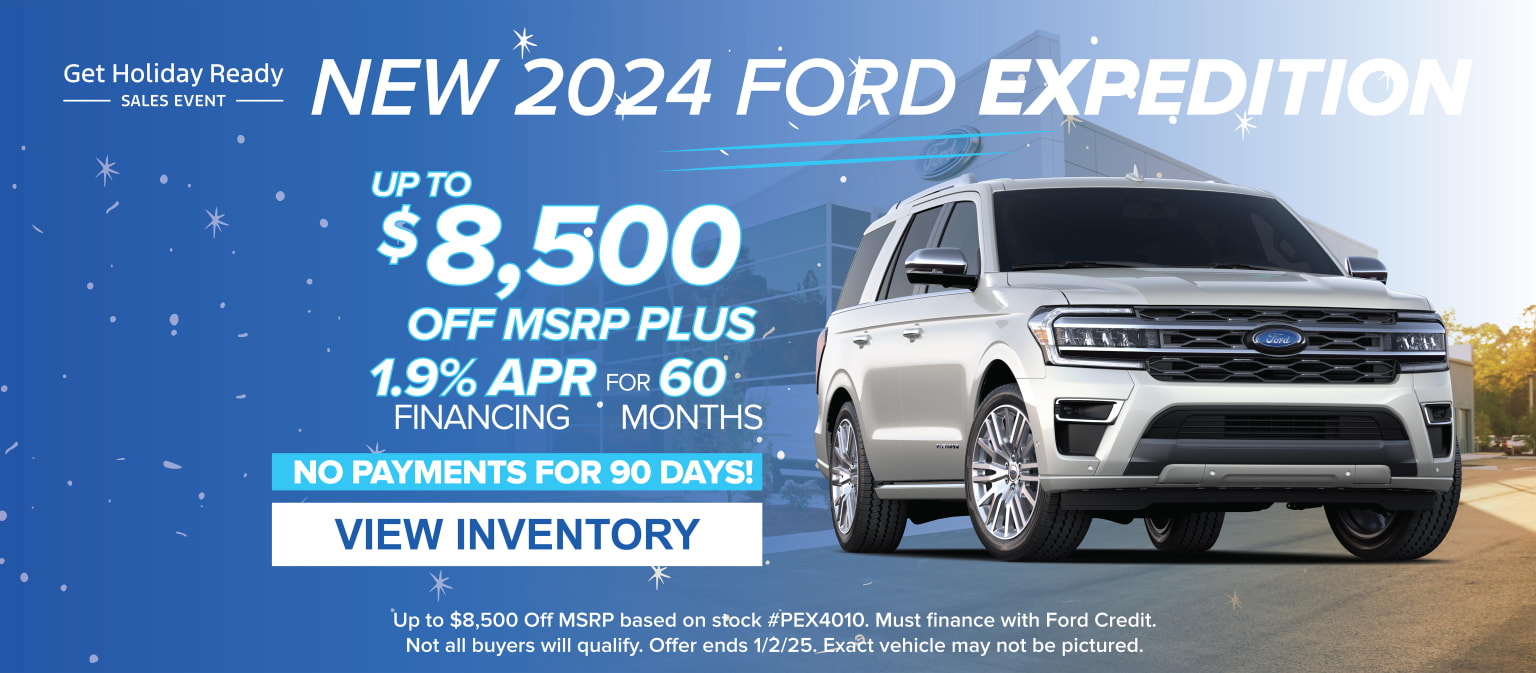 The image displays a white SUV prominently featured in the foreground, with a promotional advertisement for the 2024 model year in the background, highlighting various sales incentives and financing options.