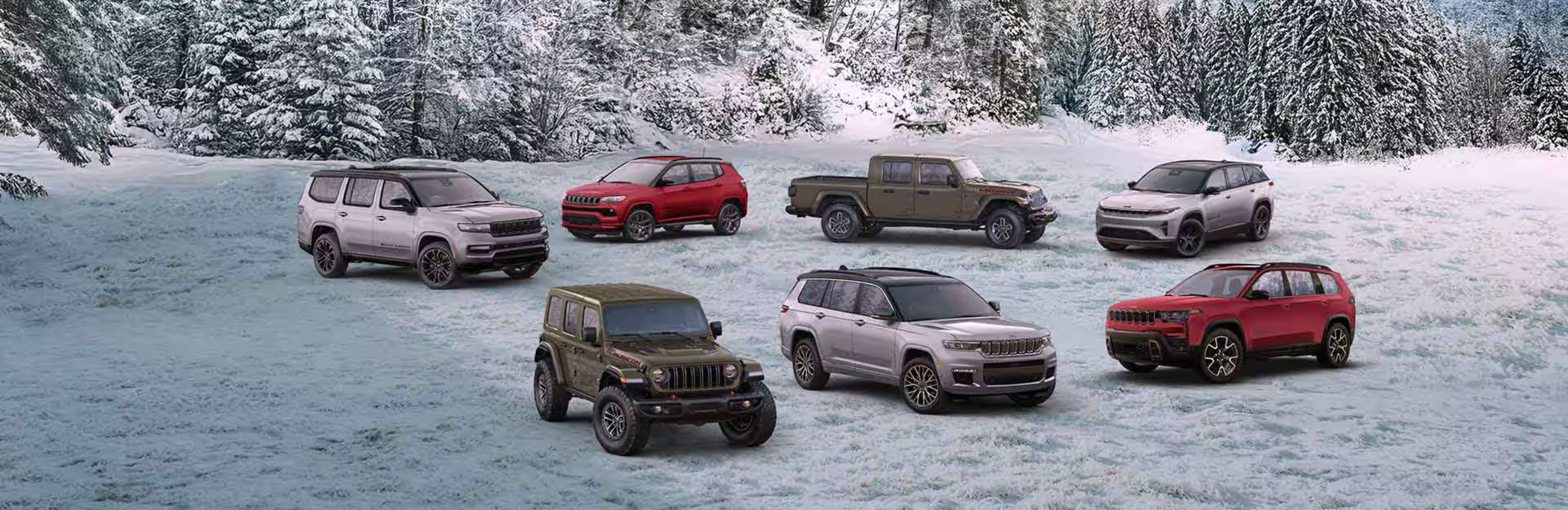 SUVs and pickup truck parked on snowy field with snow-covered trees in background.