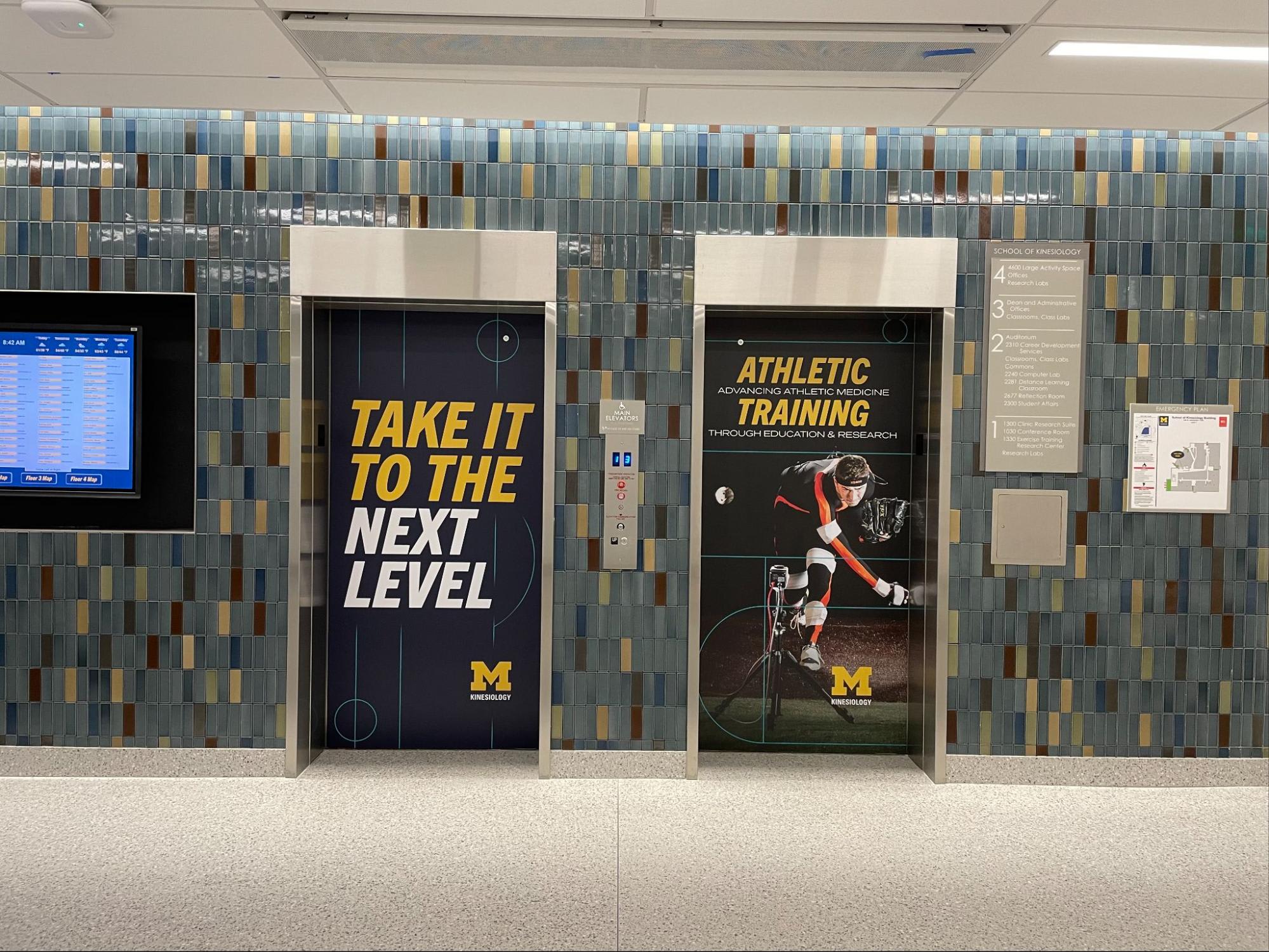 Elevator with Kinesiology's new signage