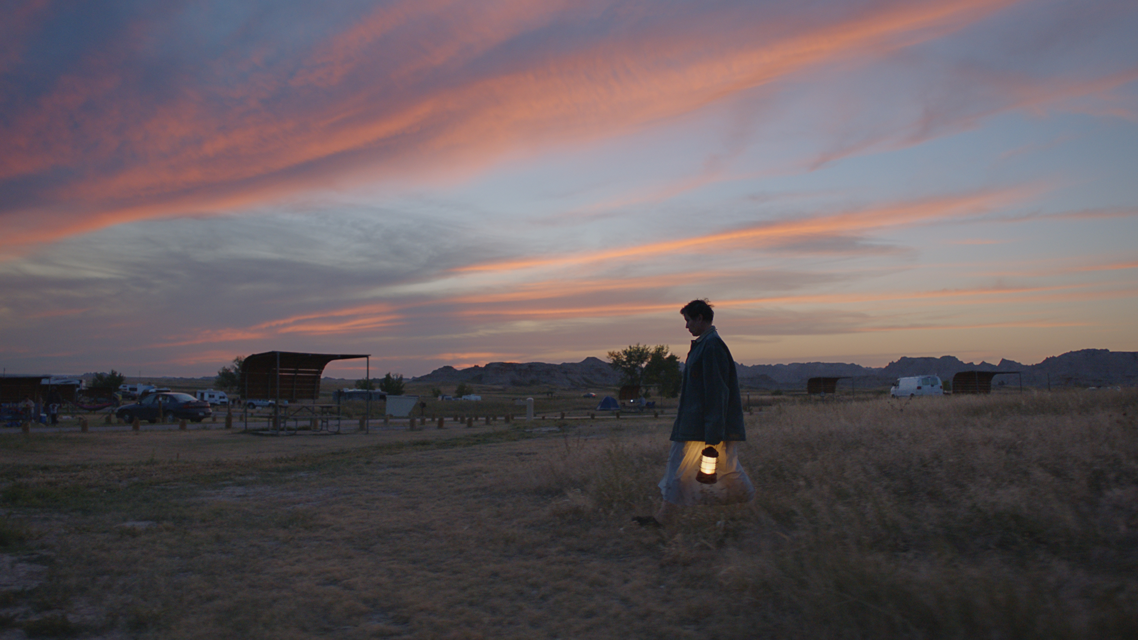 Frances Mcdormand walking with a lantern in her hand