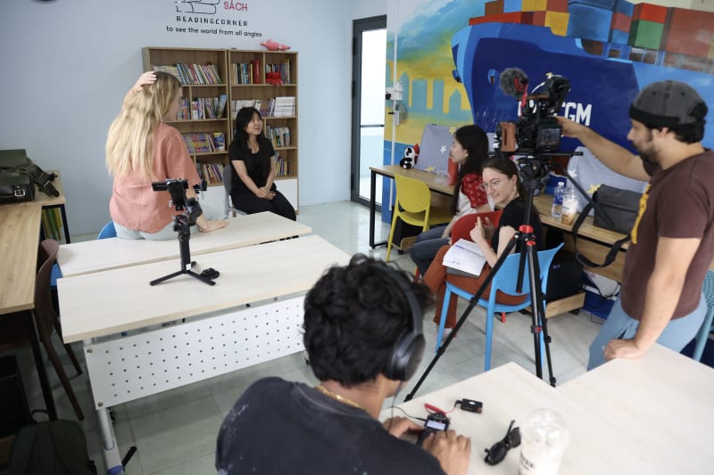 A crew member mid-interview during a documentary production