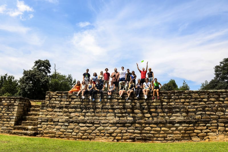 The full Documentary Outreach cohort poses together at the Iximché archaeological site, Guatemala
