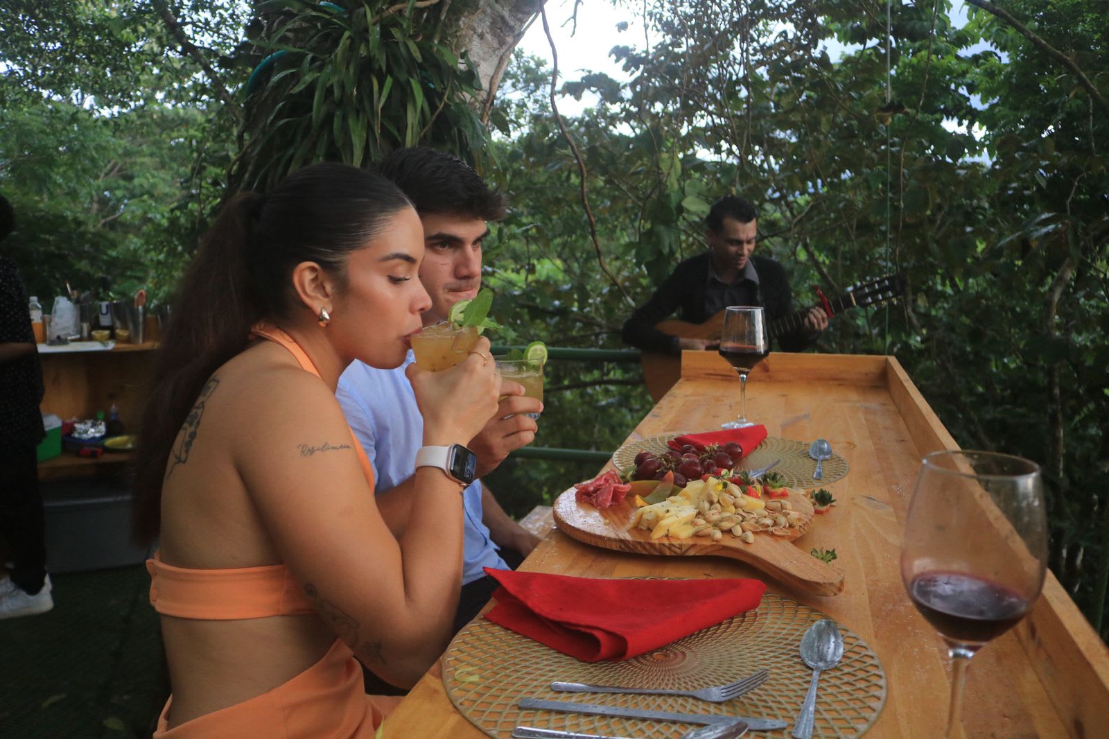 Couple dining at a viewpoint, with background music