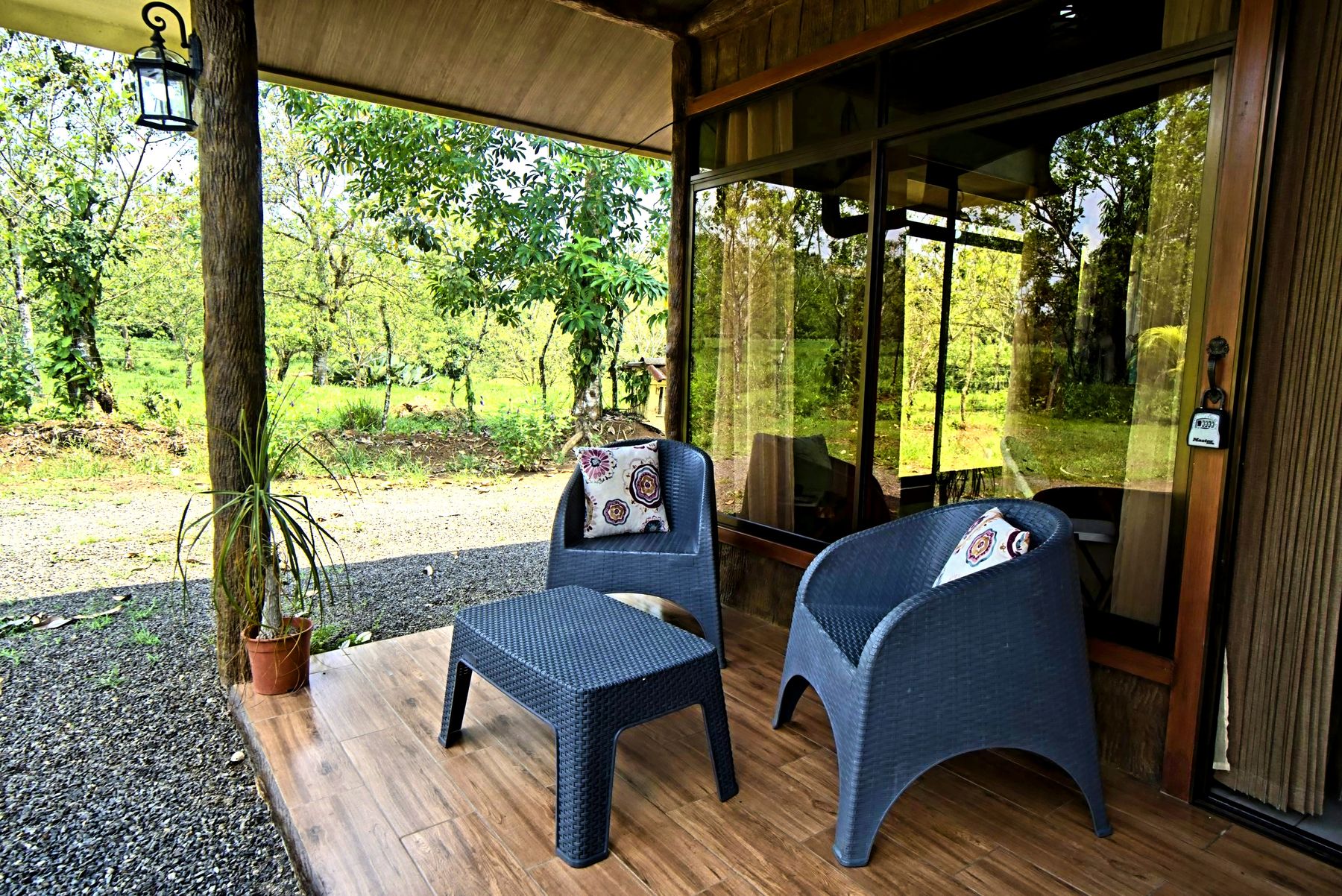 Porch with chairs and a garden view.