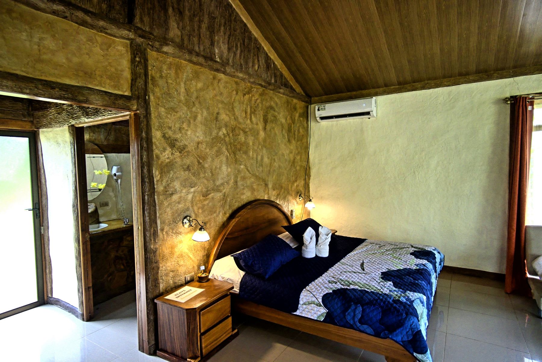 King bed and the entrance to the bathroom.