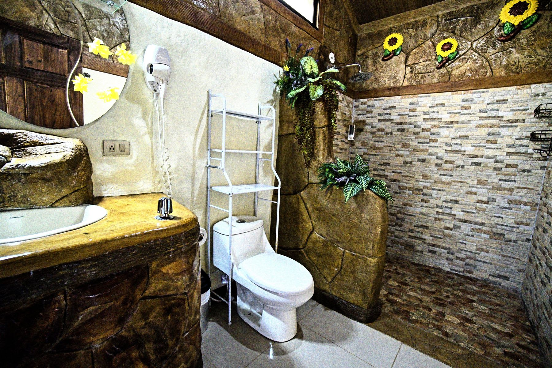 Bathroom with a stone sink, toilet and walk-in shower.