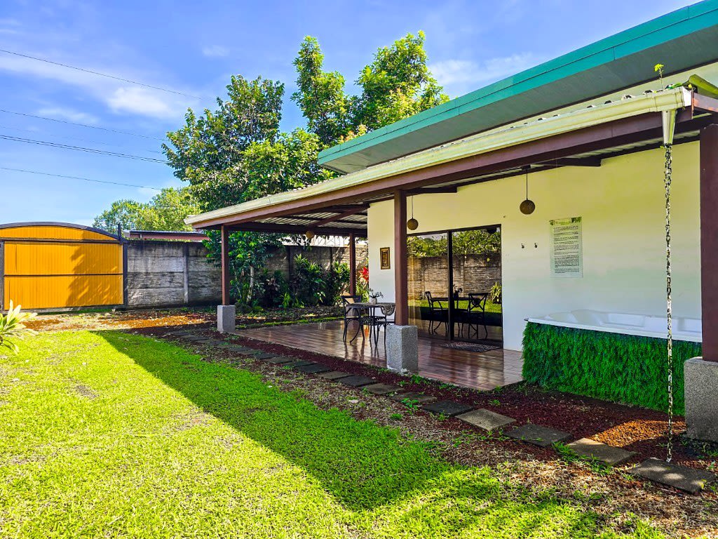 Villa Sassy exterior and garden, with the covered terrace.