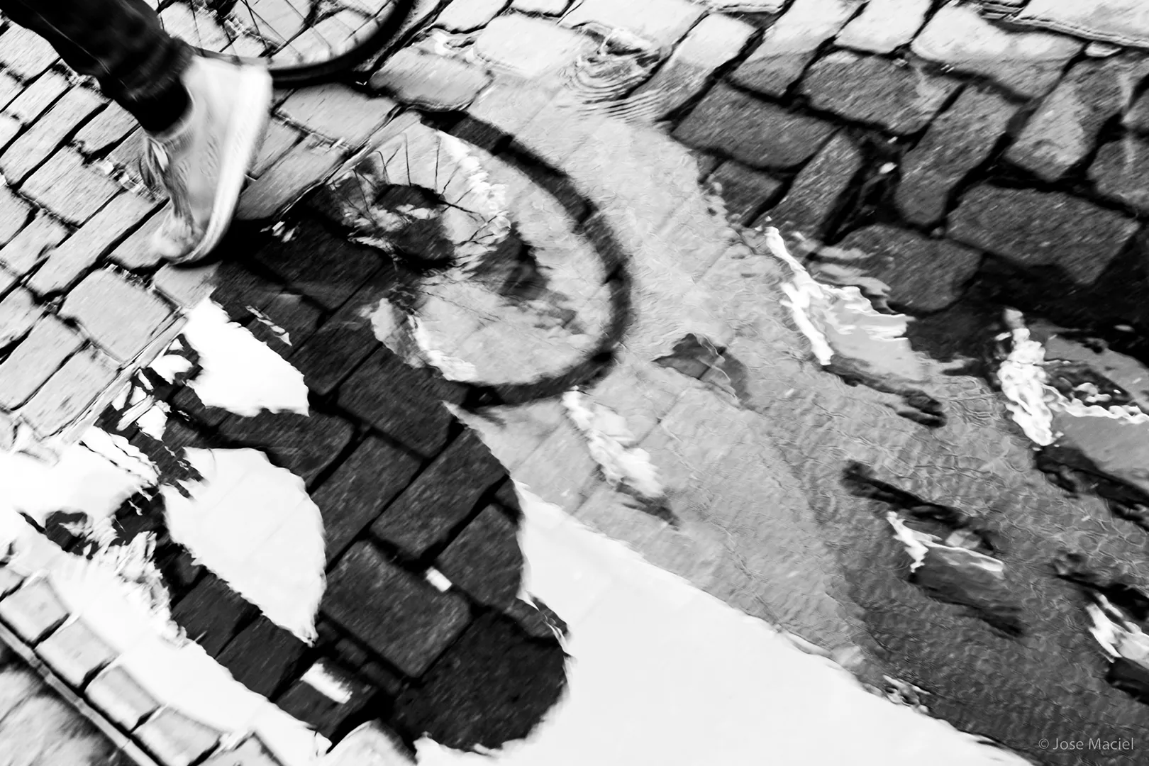 Reflection of cyclist on a puddle