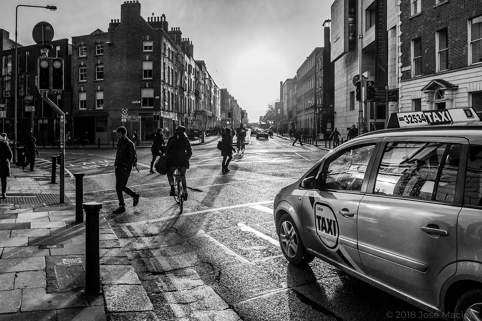 Black and white photo of commuters in a busy street