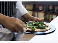 Chef holding a pizza thumbnail