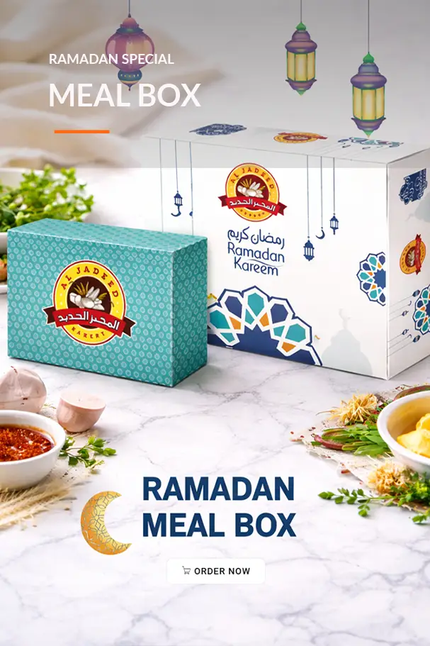 Ramadan special meal box featuring beautifully designed packaging from Al Jadned Bakery, set on a marble table with traditional dishes and garnishes, promoting an order option for festive meals during the holy month.