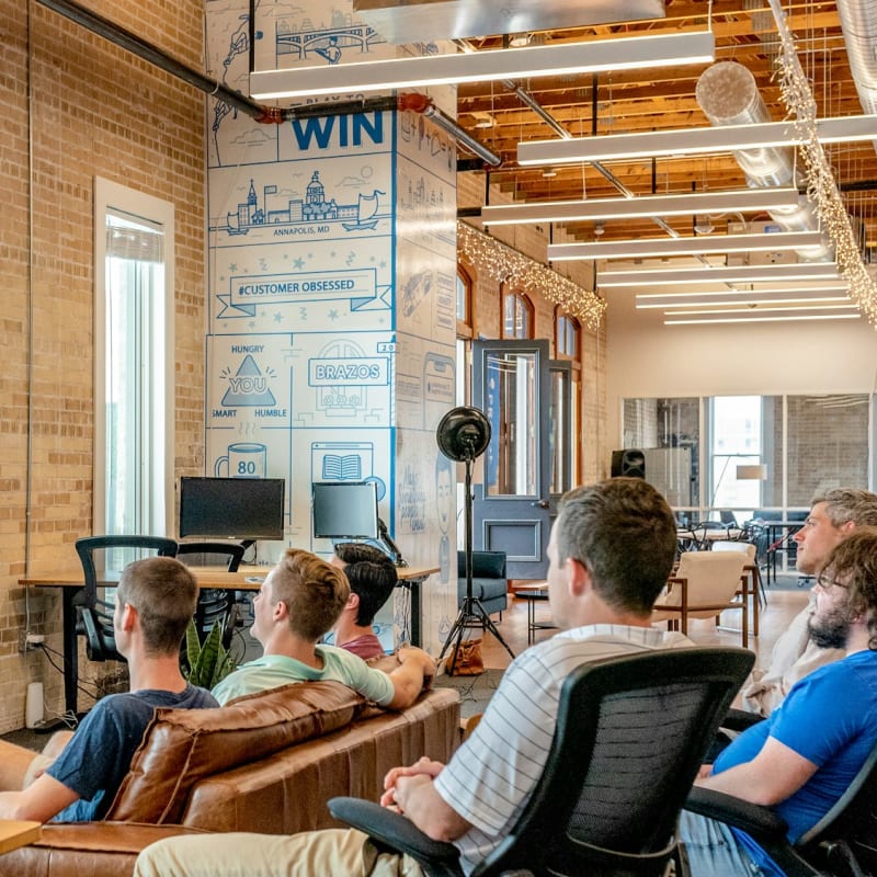 A speaker presenting to a seated audience in an open office