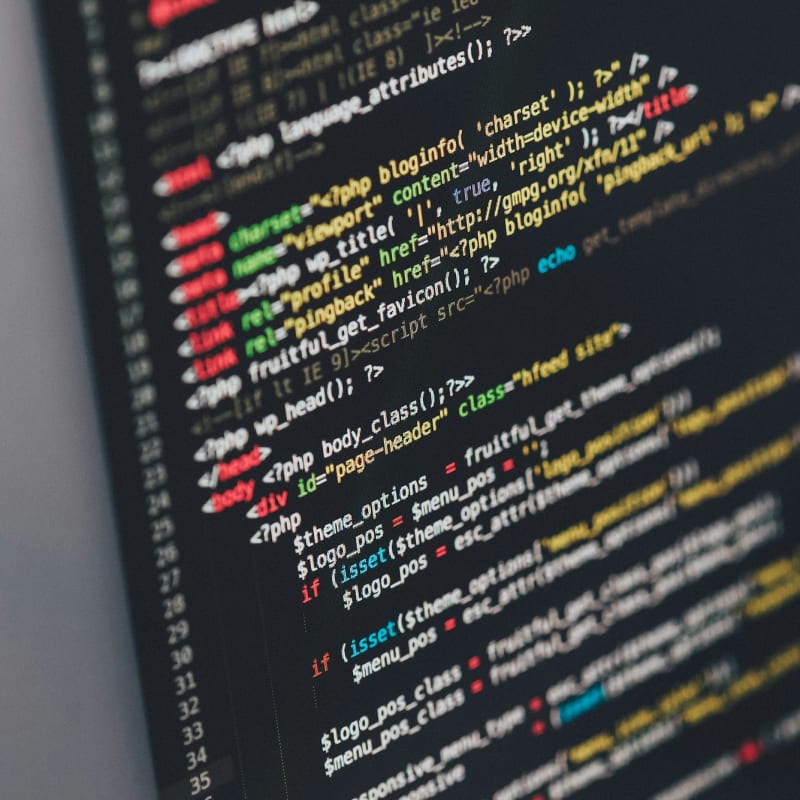 Source code on a monitor in a dark editor theme