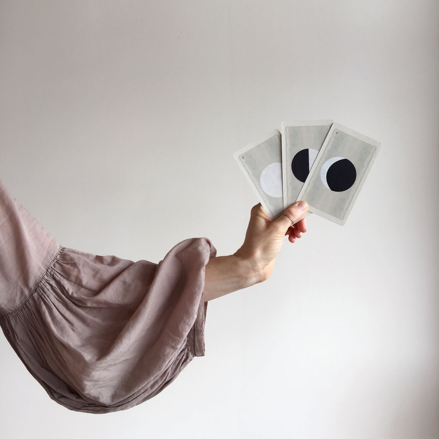 Amber holding three moon cards