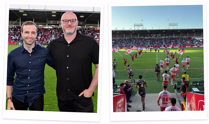 Chris and Martin smiling at a St Helens R.F.C. rugby game, with a photo of the game in progress on the field beside them.