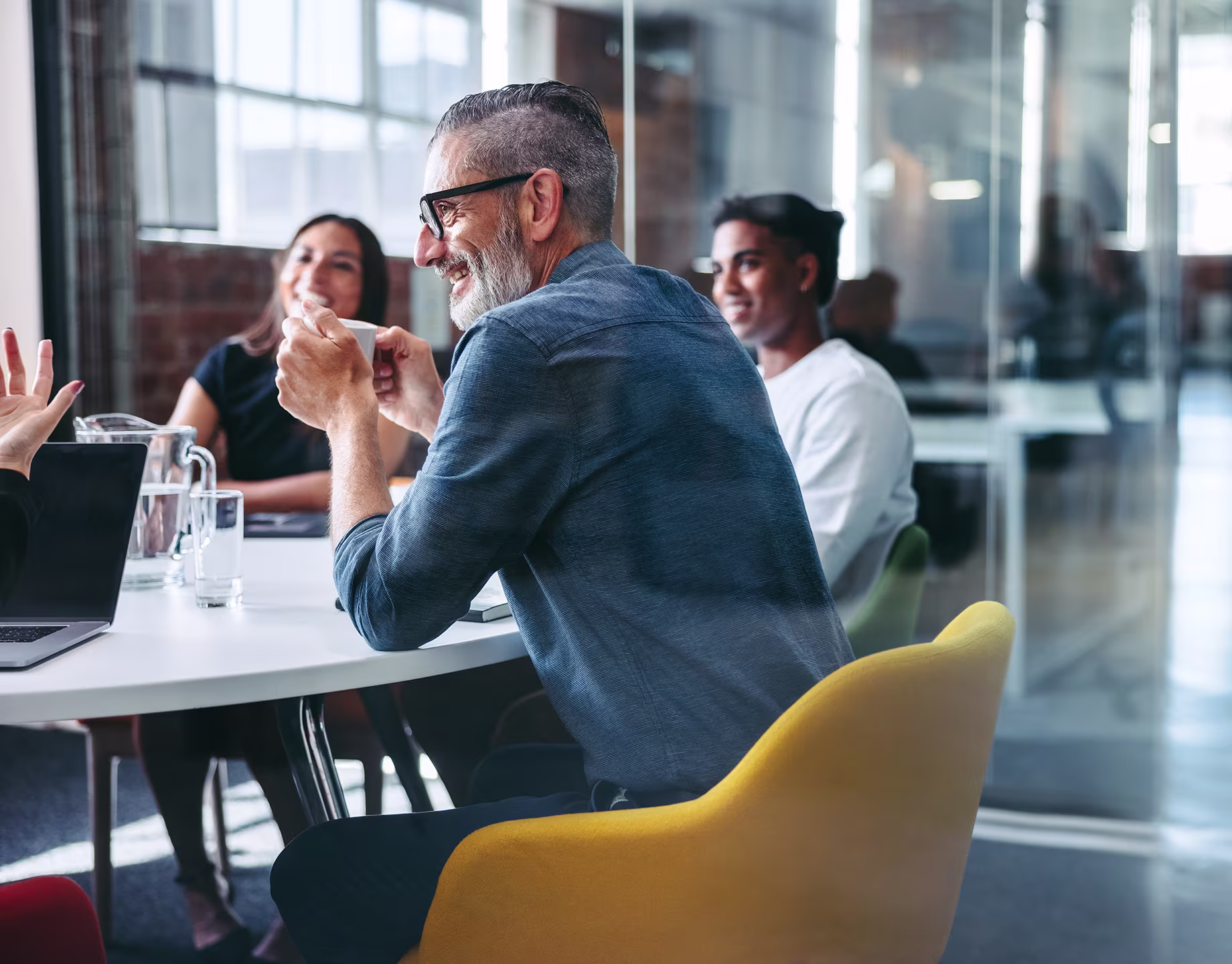 Professional team collaborating around a table in a bright, modern office space