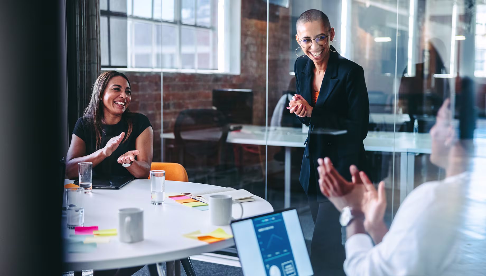 Business professional giving a presentation to team members in an office setting
