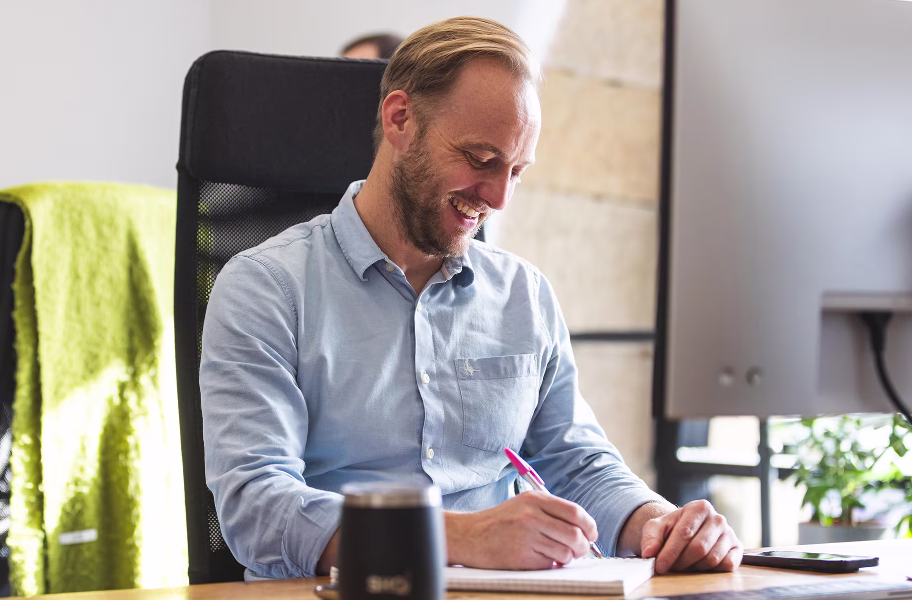 True9 team member working in the new Salts Mill office with bright natural light