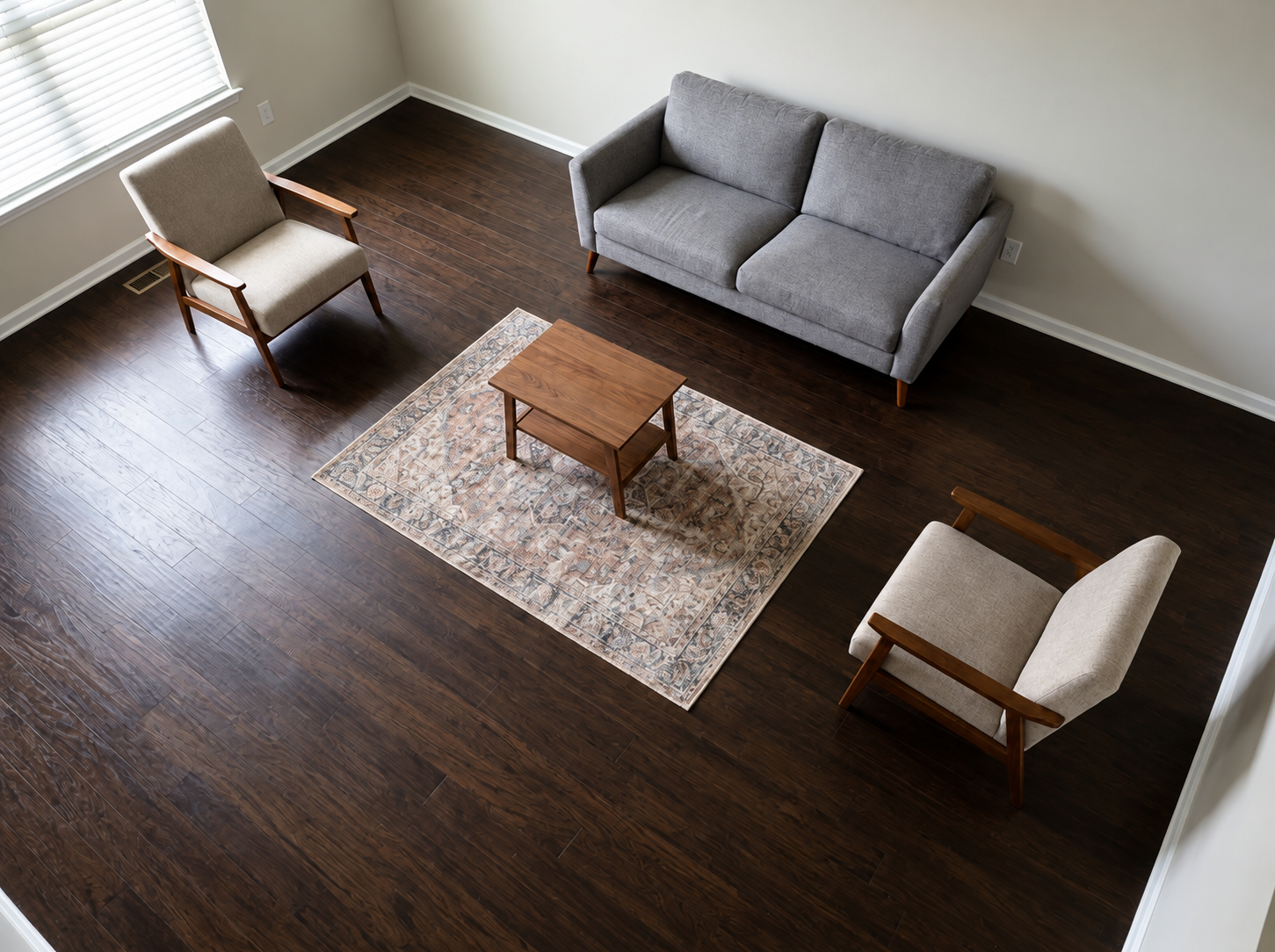 Living room with grounded furniture arrangement creating purpose and visual stability