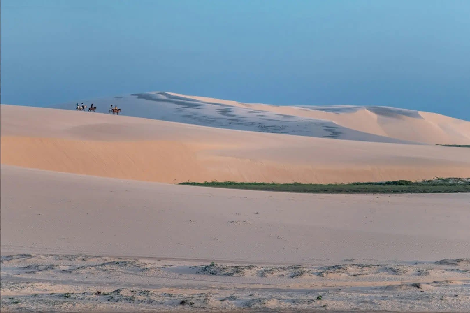 Jericoacoara. Sand with people on horseback