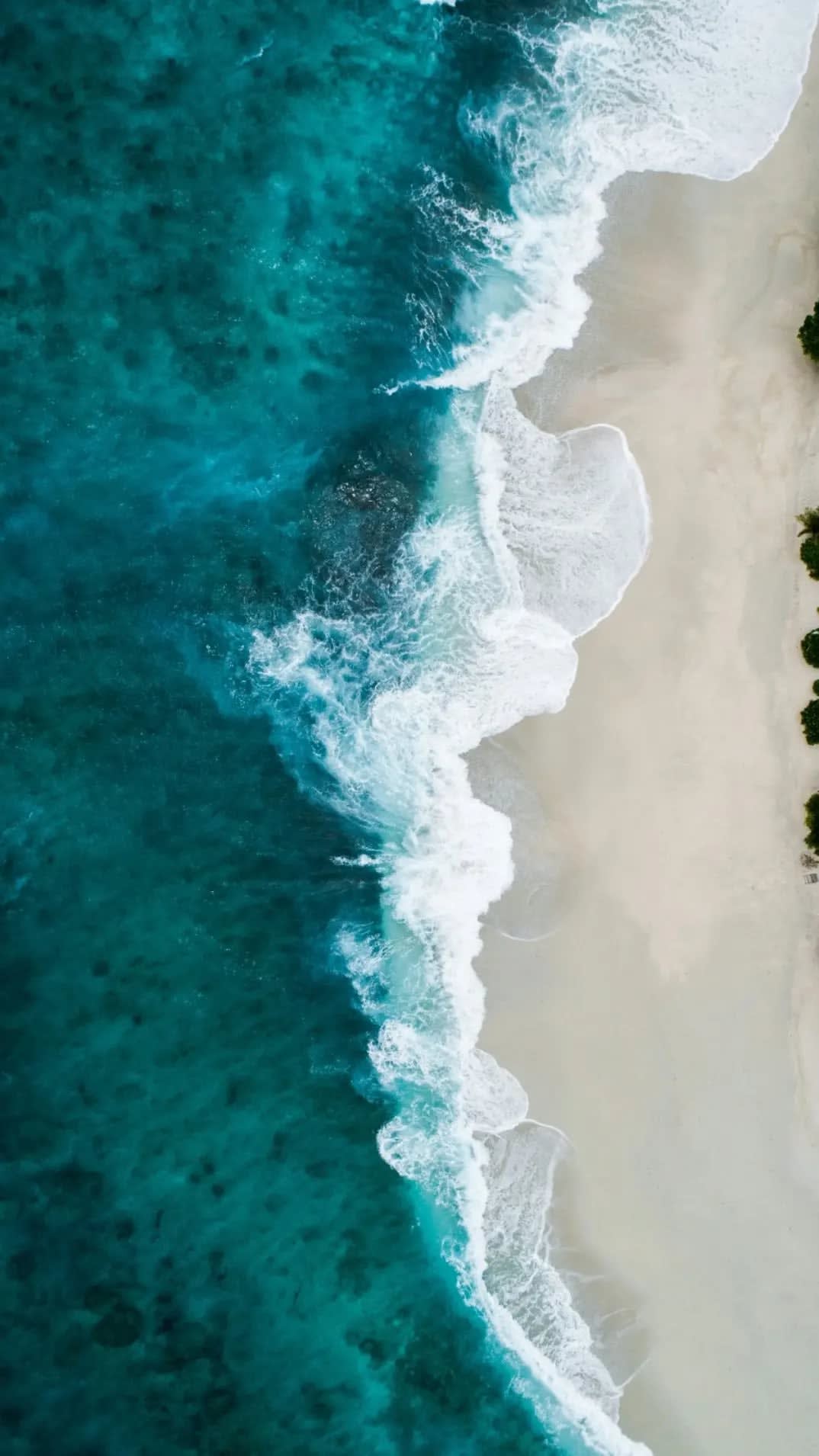 White sand in front of a beach and a cloudy white sky. Jericoacoara