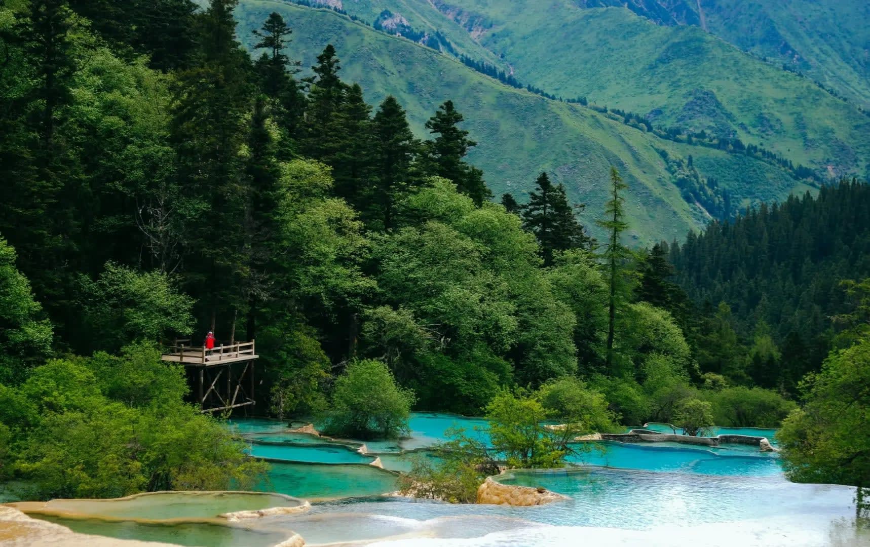 Puddles in front of a mountain with trees, Jiuzhaigou
