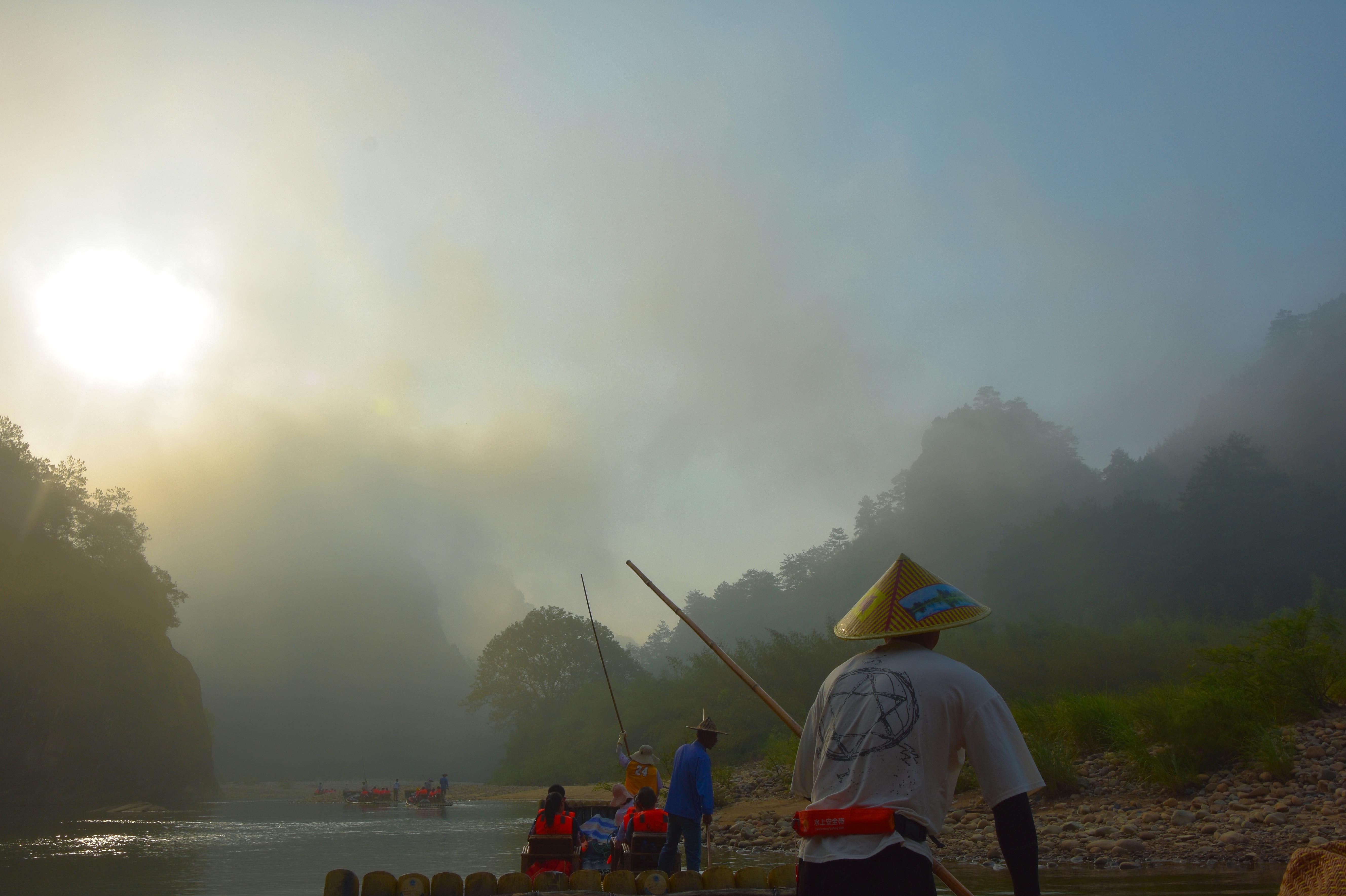 Bamboo raft ride on the Nine Bends River through the red sandstone gorge of Wuyi Mountain China