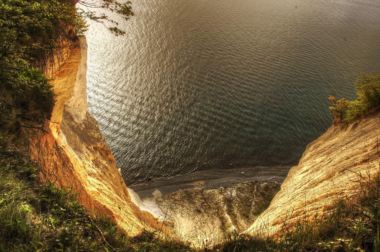 Staircase path descending through Møns Klint cliff face to the pebble beach at the foot of the cliffs