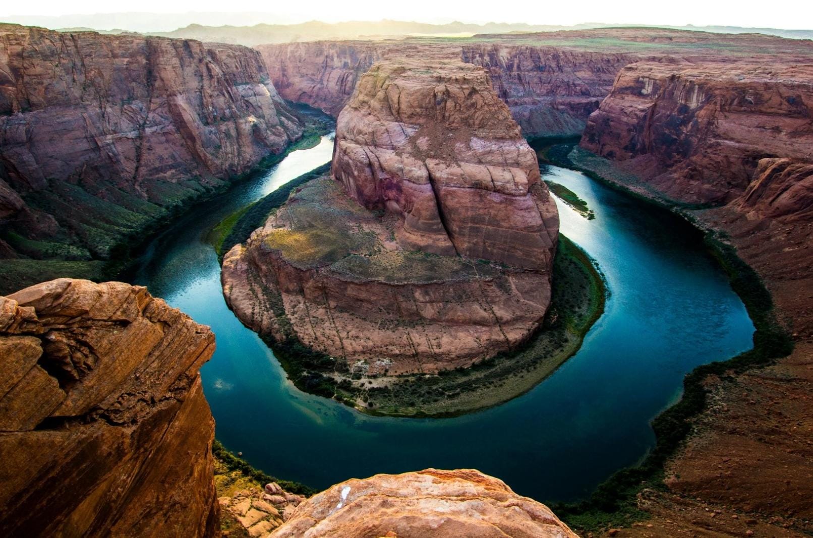 A river winding around a massive rock in the Grand Canyon