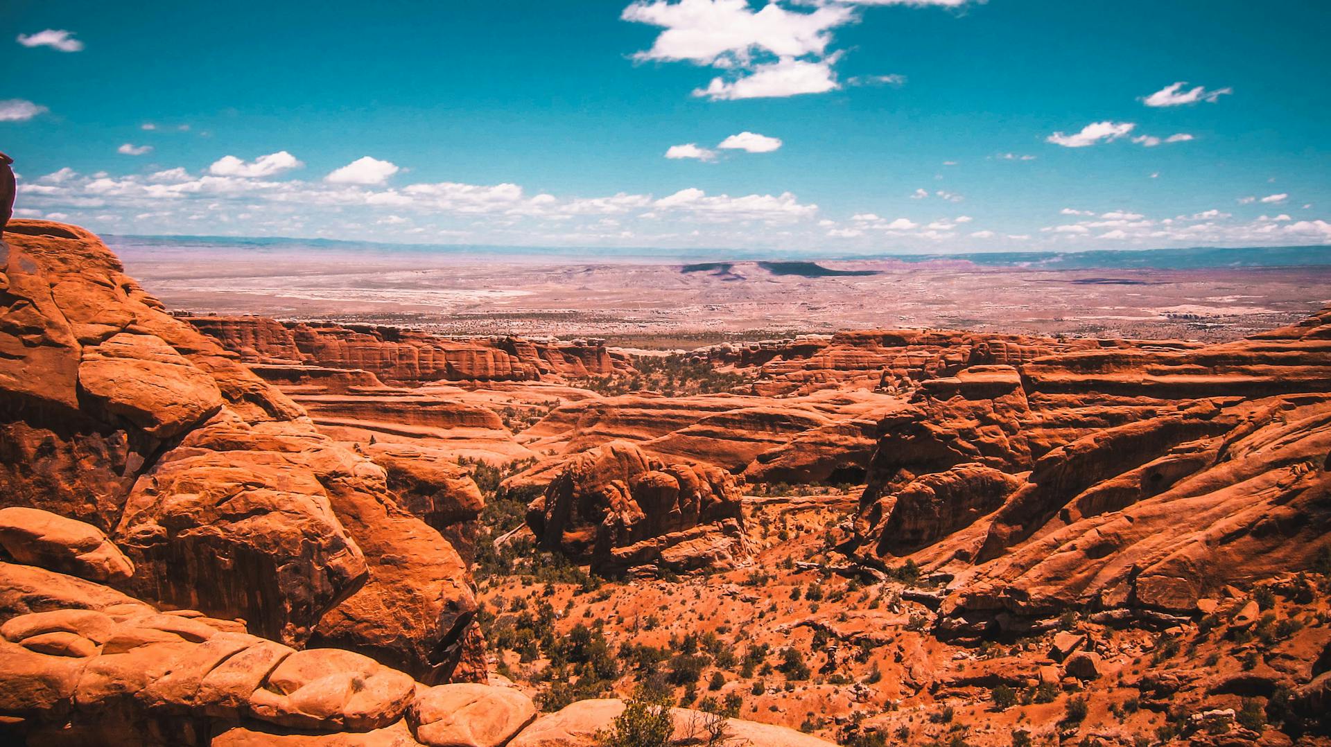 Young person standing on a rock, admiring the breathtaking beauty of the Grand Canyon