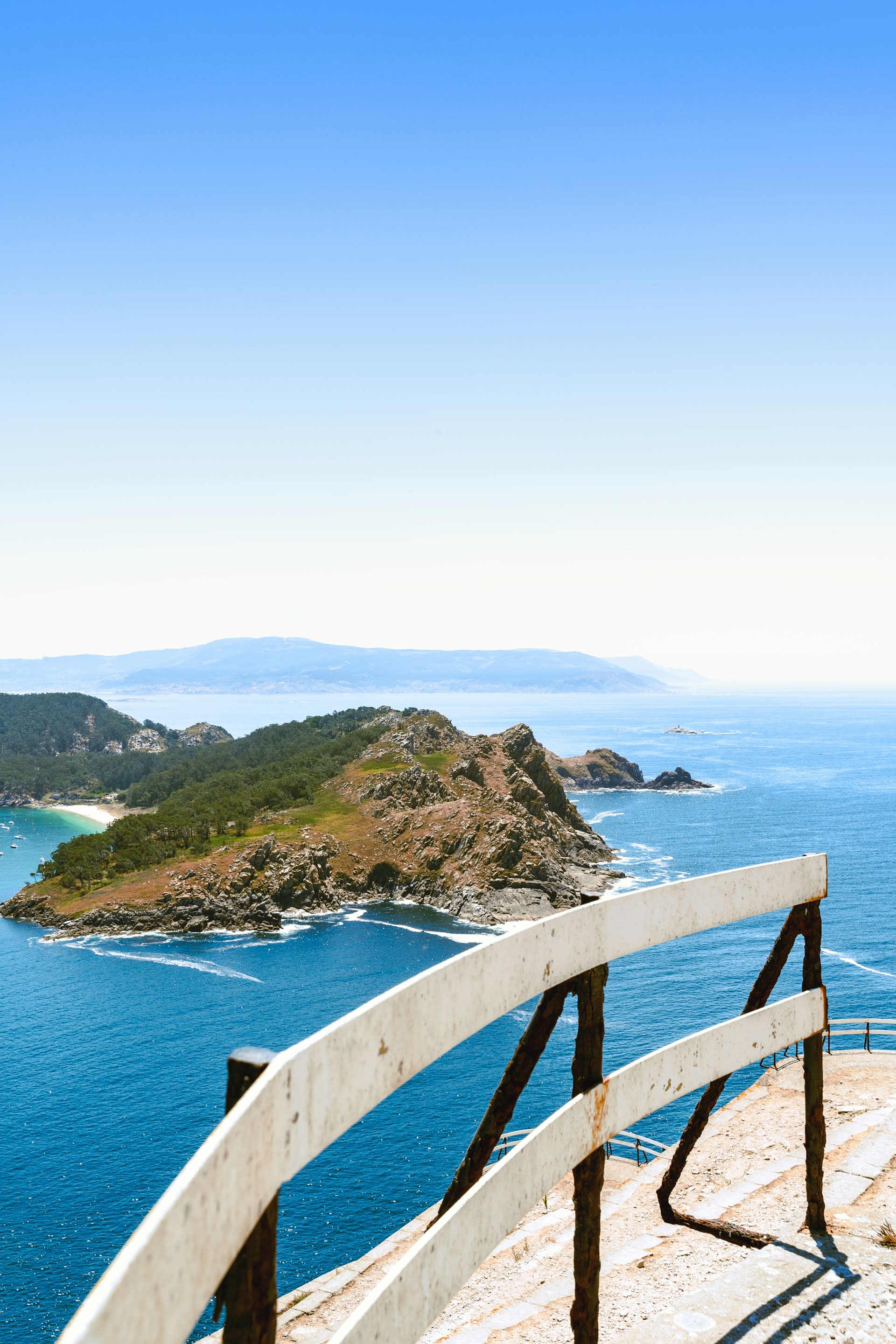 Playa de Rodas on the Cíes Islands with shallow turquoise water and forested granite slopes behind
