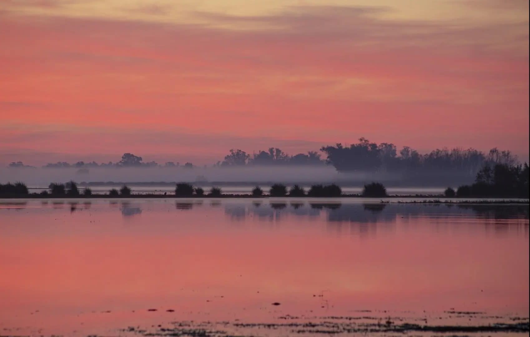 reddish lake at sunset