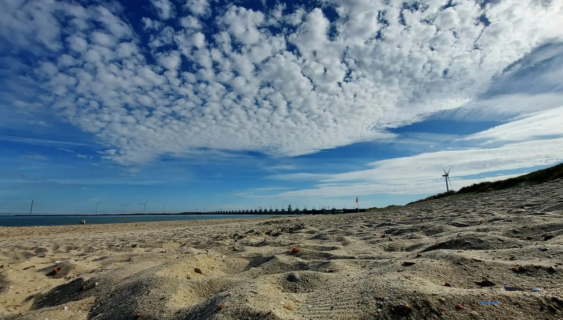 beach sand with windmills in the background, Park Oosterschelde