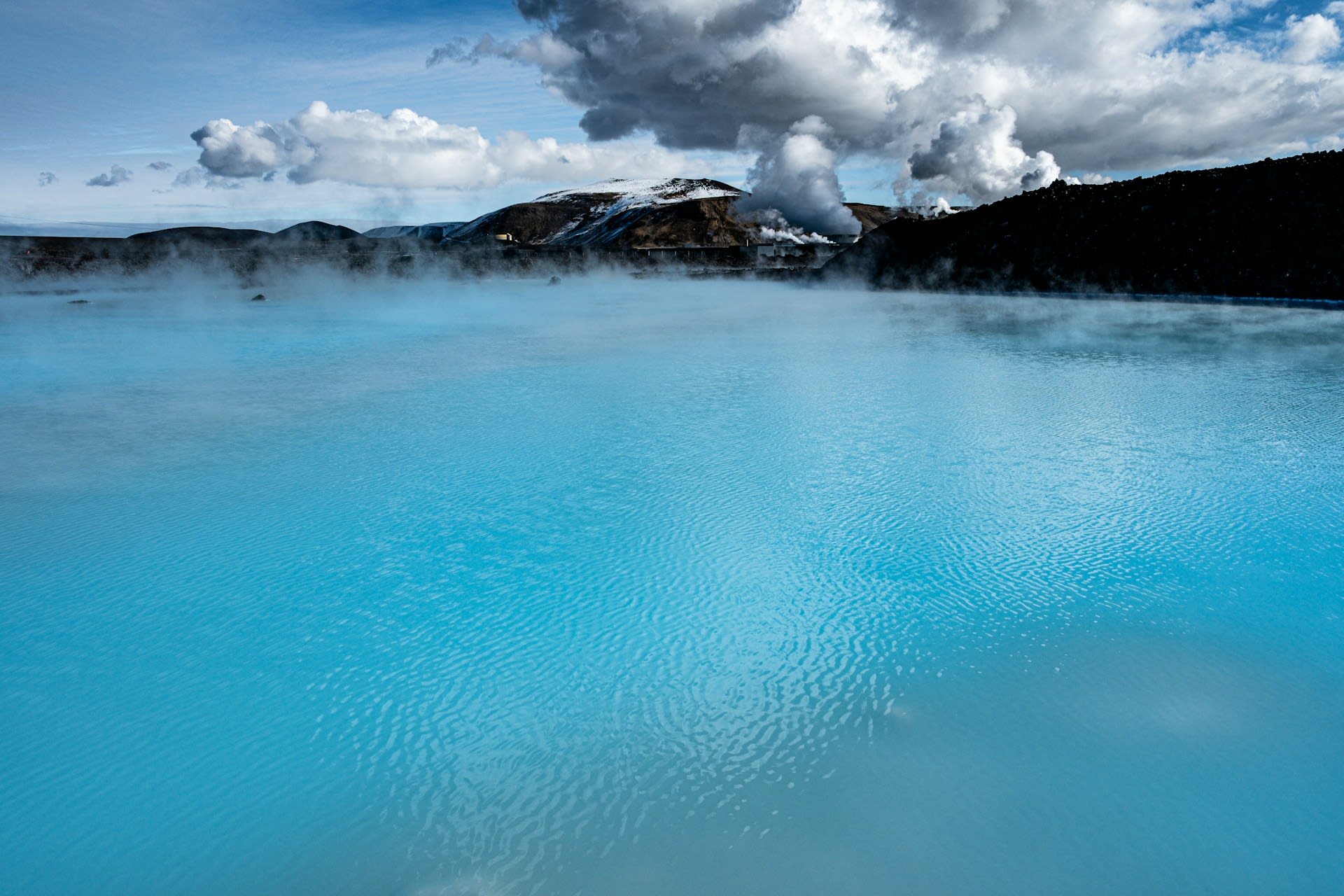 Bathers relaxing in the warm mineral-rich waters of the Blue Lagoon geothermal spa in Iceland