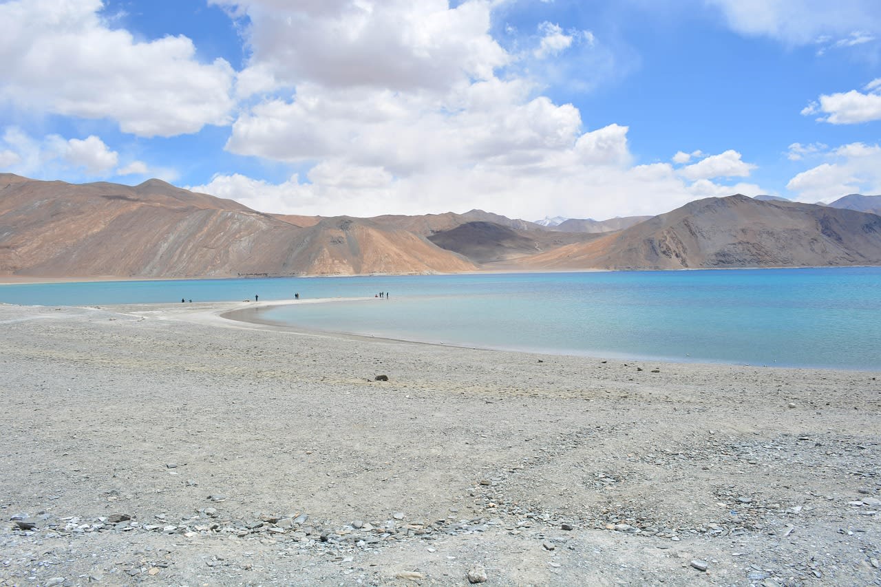 Prayer flags on a mountain pass in Ladakh with the Himalayan range in the background
