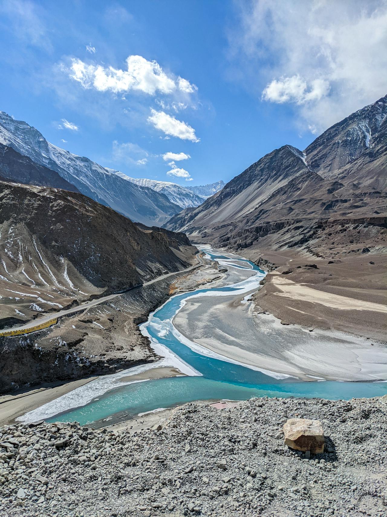 Snow-covered peaks and prayer flags above the Pin Valley National Park in Spiti Himachal Pradesh
