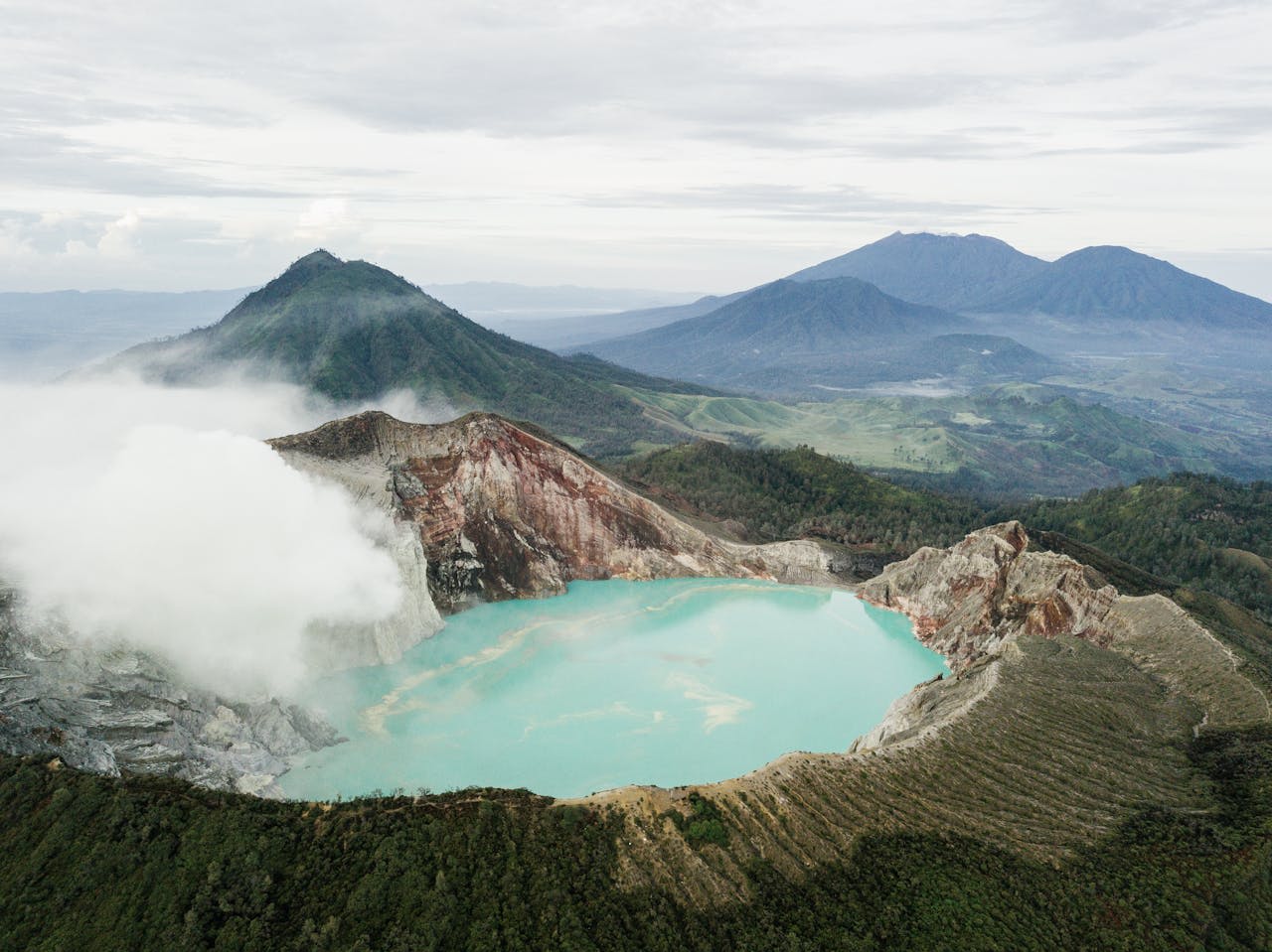 Sulfur miner carrying enormous load of yellow sulfur down from Kawah Ijen crater in East Java