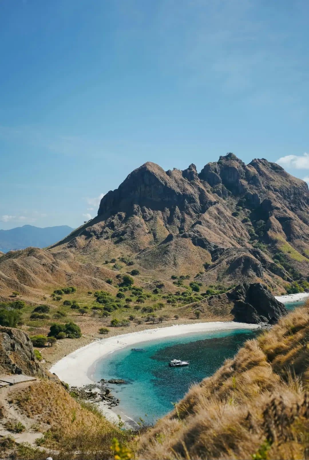 Beach with a boat and mountains, Komodo Island