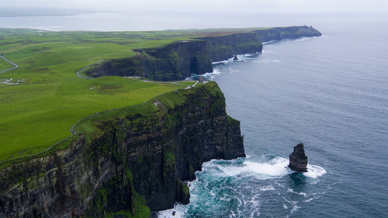 O'Brien's Tower at the edge of the Cliffs of Moher with the Aran Islands visible in the Atlantic