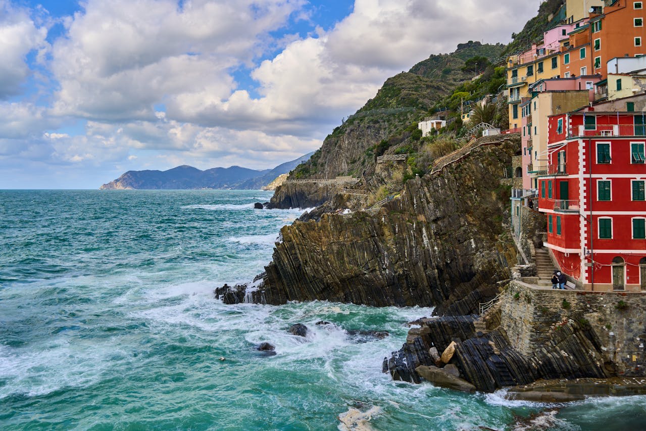 Colourful houses of Manarola village stacked on the cliff above the turquoise Ligurian Sea Cinque Terre Italy