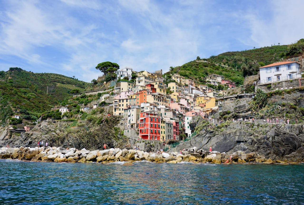 Vernazza harbour with fishing boats and colourful buildings above the rocky Ligurian coast Cinque Terre