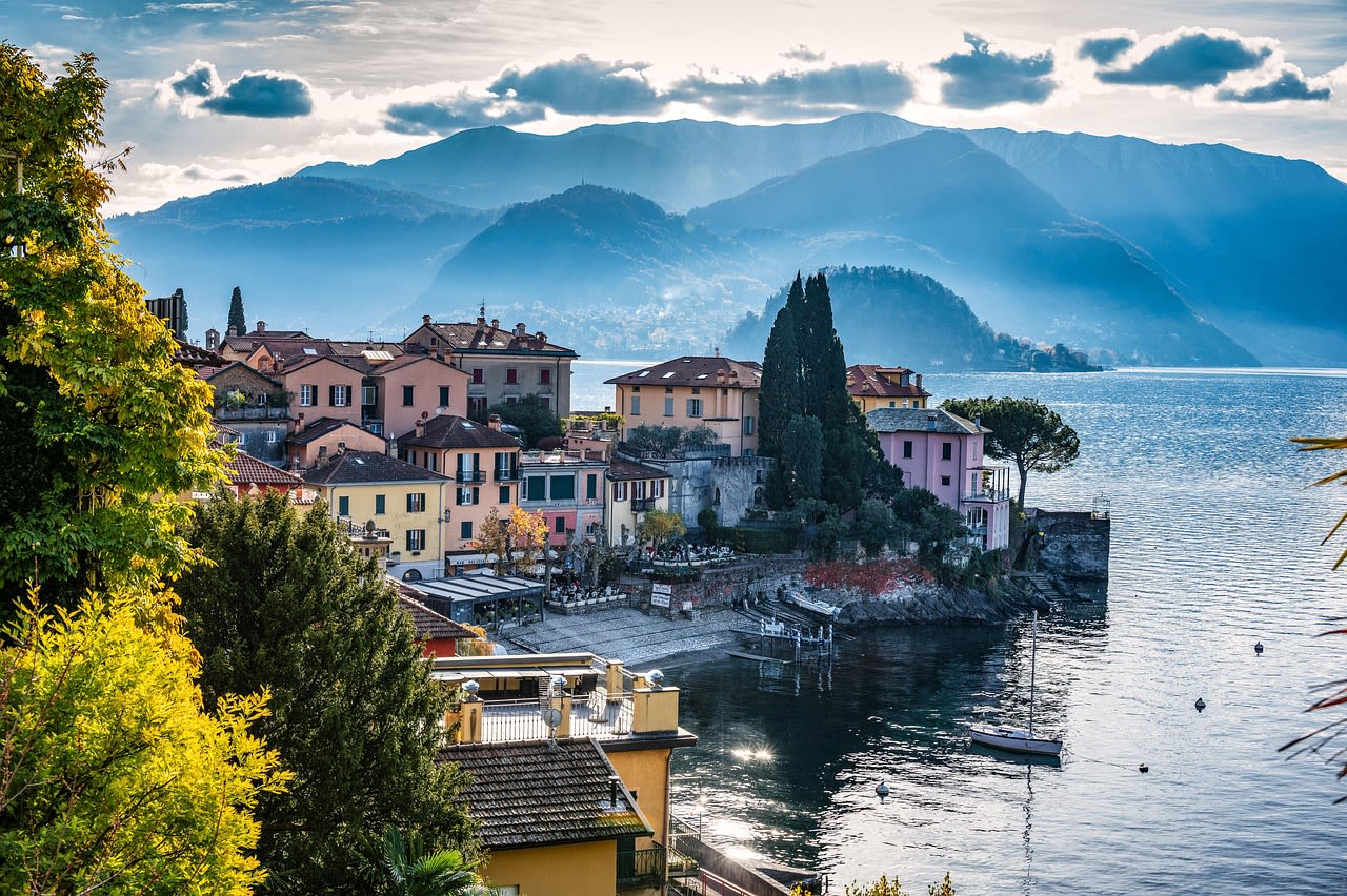 Lake Como with Villa del Balbianello on its promontory and the Alps reflected in the blue water of the Lombard lake Italy
