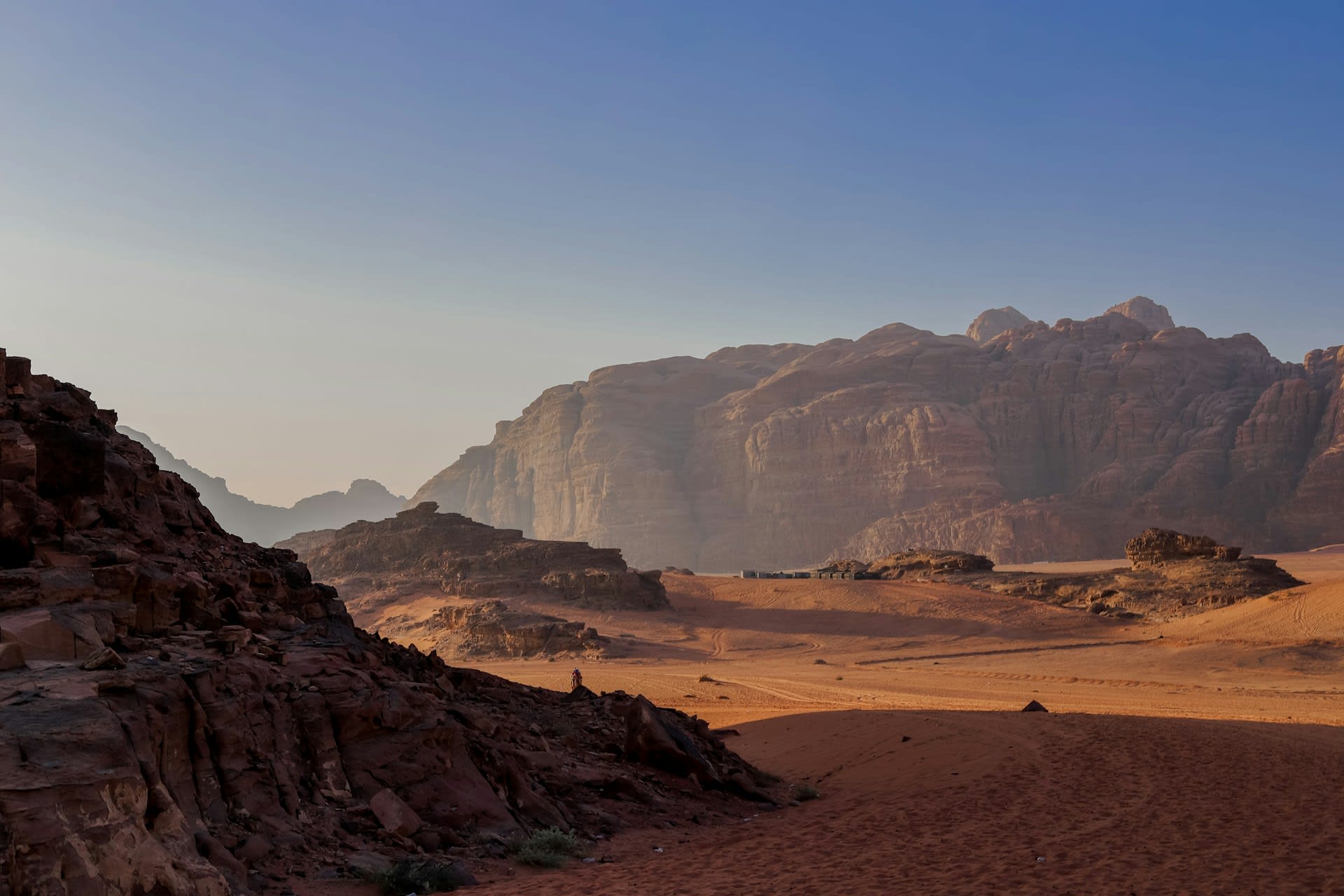 Sandstone rock pillars glowing red at sunset in the Wadi Rum Protected Area in southern Jordan