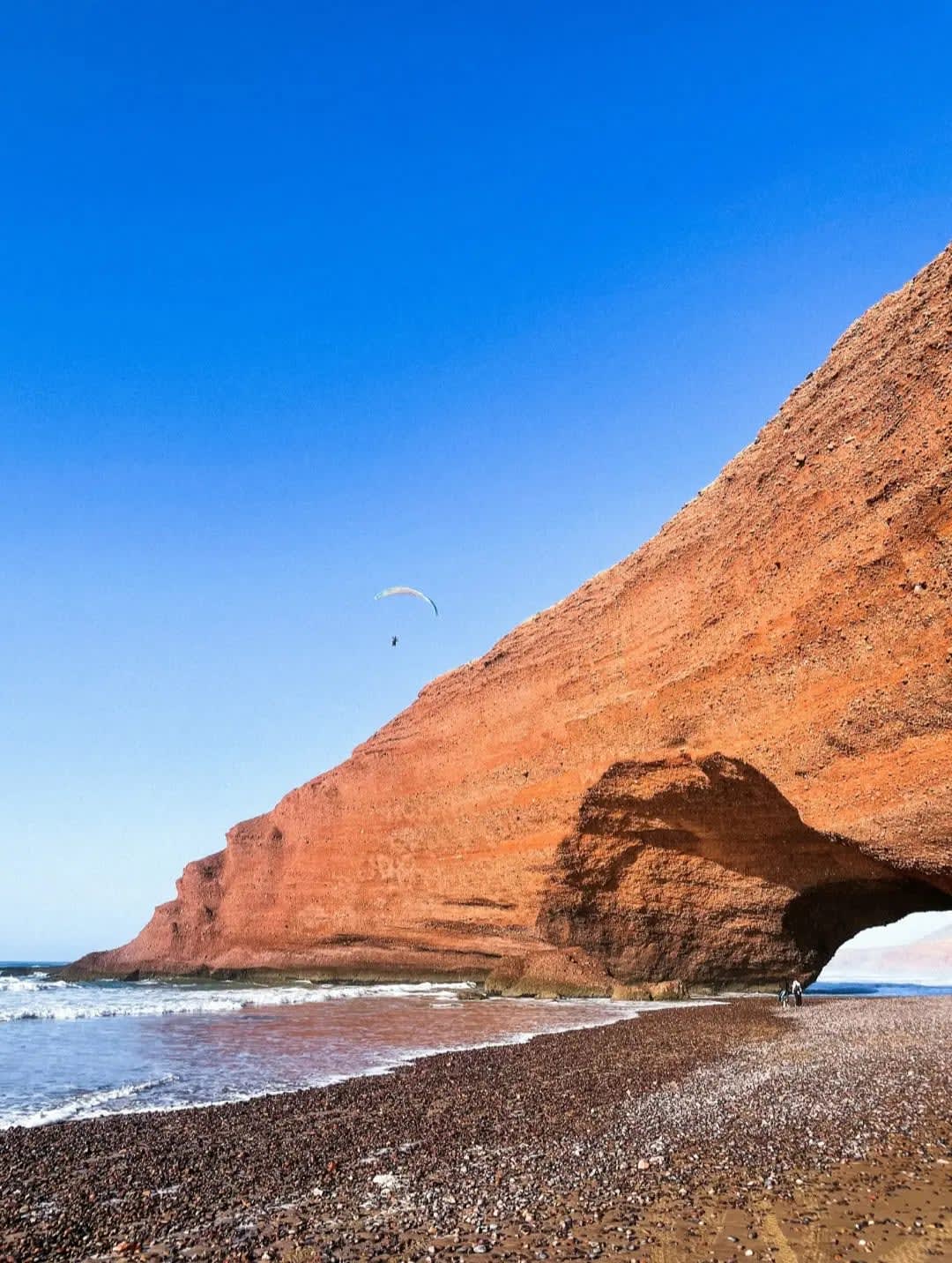 sunset at Legzira Beach highlighting the prominent rock formation