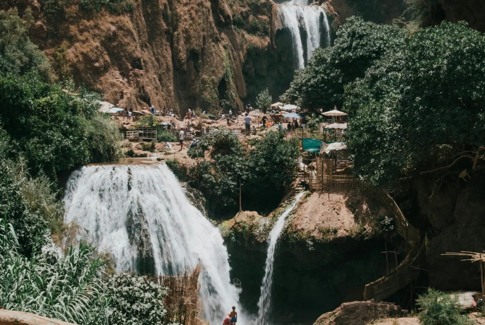 three monkeys in front of a waterfall, Ouzoud Waterfalls