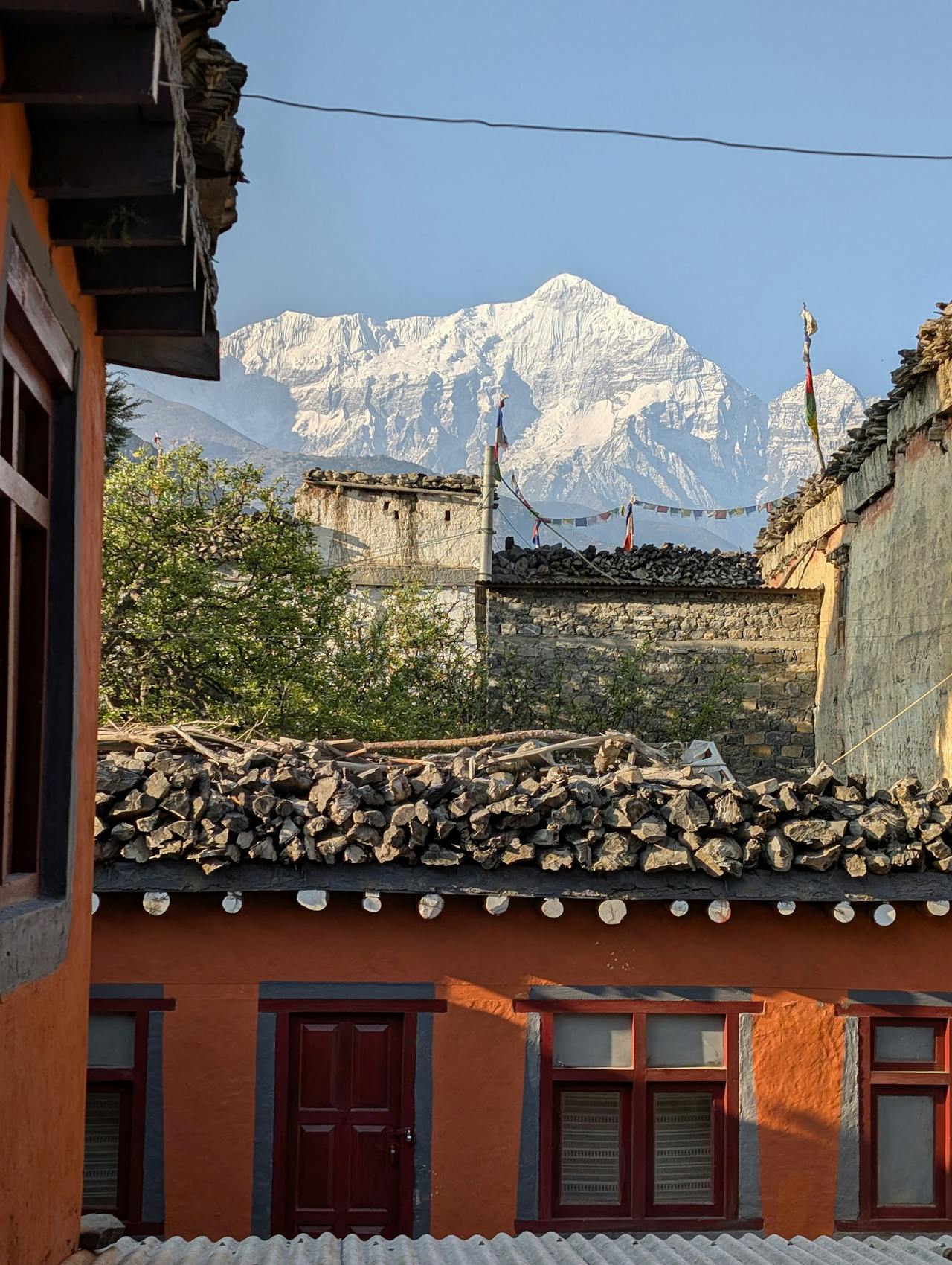 Tibetan Buddhist monastery with white walls and red roof in the Mustang high-altitude desert Nepal