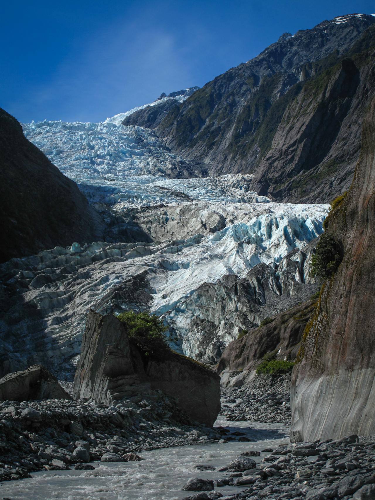 Aerial view of Franz Josef Glacier with the Southern Alps peaks and coastal rainforest in New Zealand